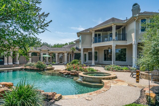 view of pool featuring an in ground hot tub and a patio