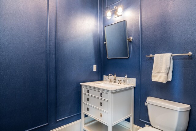 bathroom featuring toilet and vanity