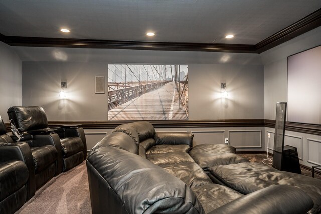 carpeted home theater room with crown molding