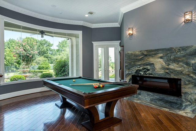 rec room with ceiling fan, pool table, a stone fireplace, and dark hardwood / wood-style flooring