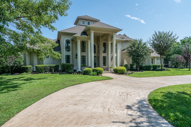 greek revival inspired property with a front lawn