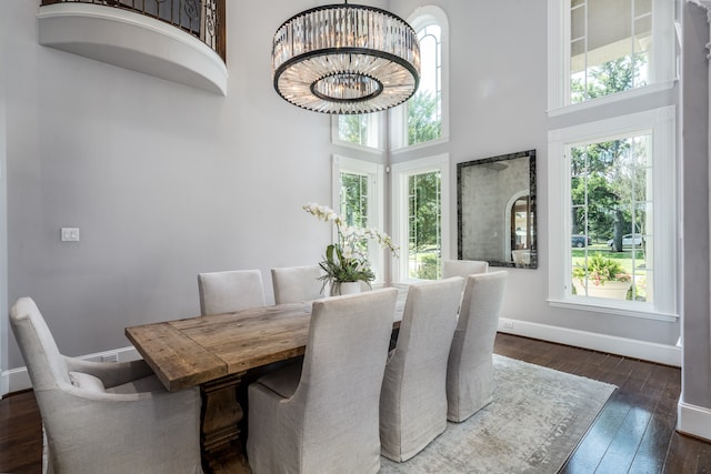 dining room with a notable chandelier, a high ceiling, and dark hardwood / wood-style floors