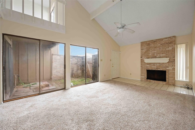 unfurnished living room featuring light carpet, a large fireplace, ceiling fan, beam ceiling, and high vaulted ceiling