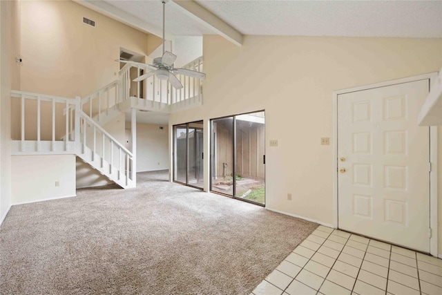 unfurnished living room featuring beam ceiling, light carpet, high vaulted ceiling, and ceiling fan