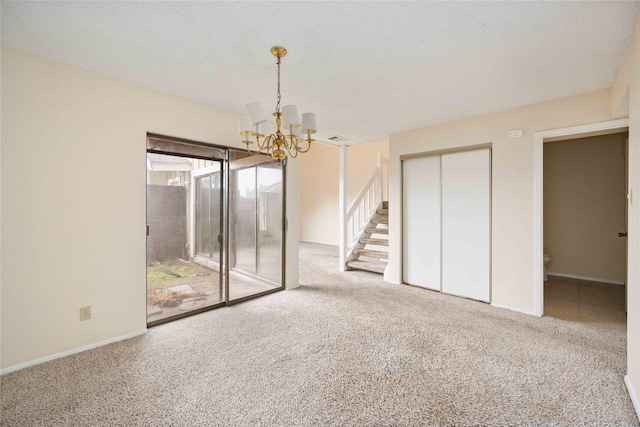 interior space featuring a chandelier and a textured ceiling