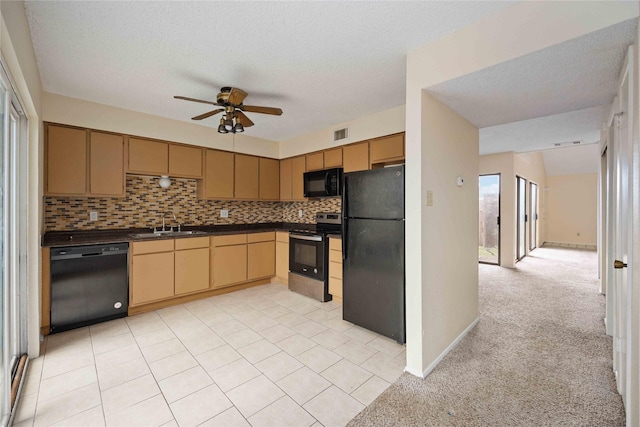 kitchen with light carpet, black appliances, decorative backsplash, ceiling fan, and a textured ceiling