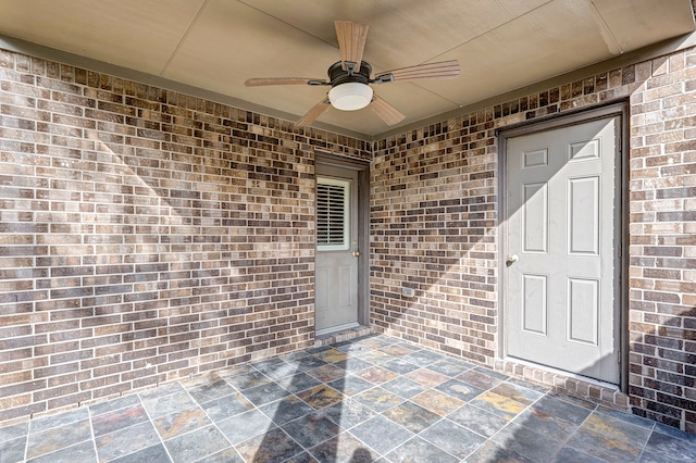 doorway to property with ceiling fan and a patio