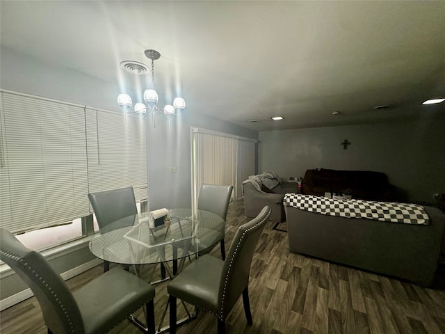 dining room featuring dark wood-type flooring and a chandelier