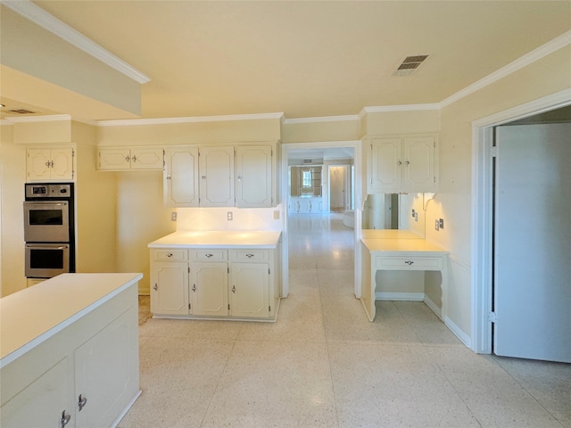 kitchen featuring white cabinetry, ornamental molding, and double oven