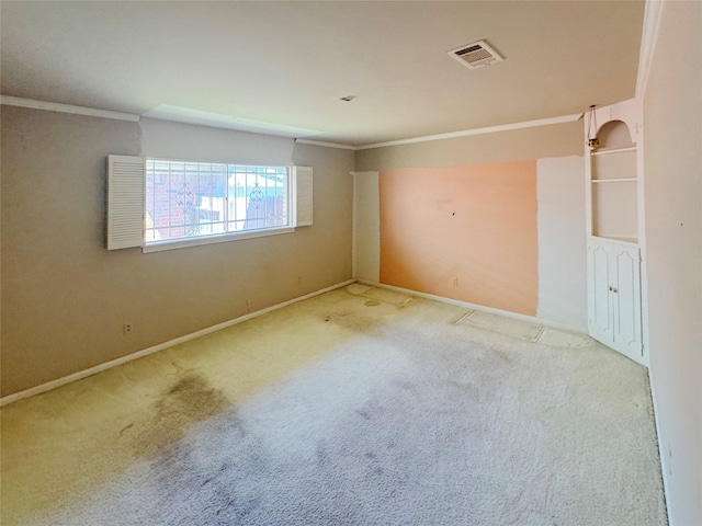 carpeted spare room with crown molding