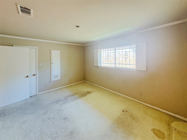 carpeted empty room featuring crown molding