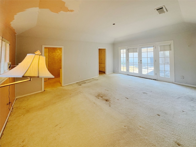 empty room featuring lofted ceiling and light colored carpet