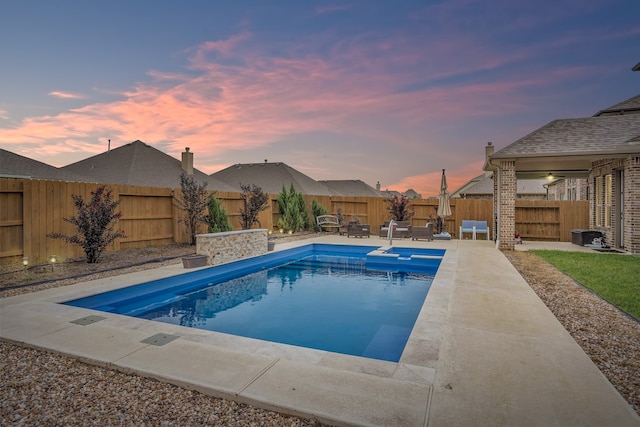 pool at dusk with a patio