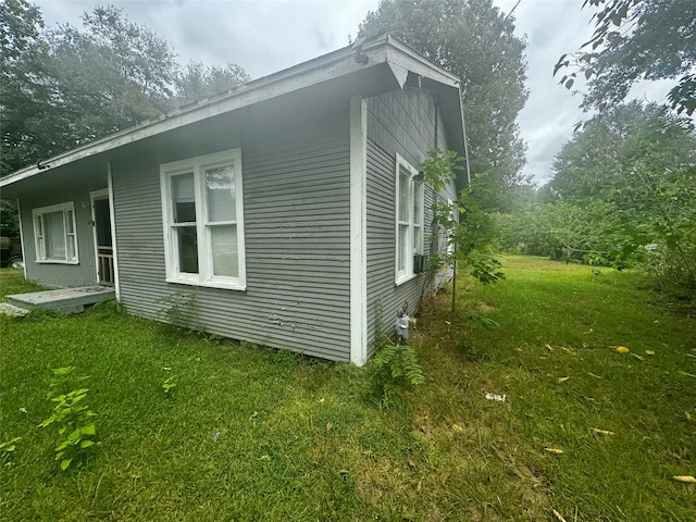 view of property exterior featuring a lawn