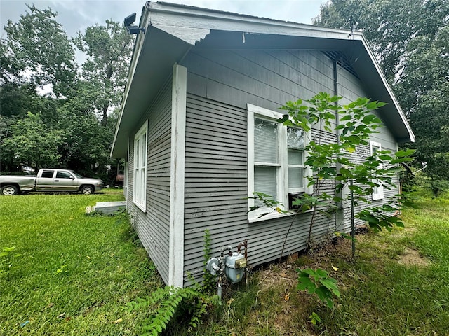 view of side of property with a lawn