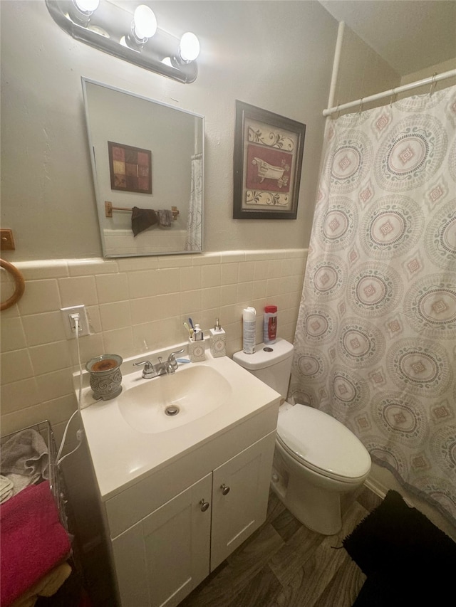 bathroom with tile walls, toilet, decorative backsplash, and vanity