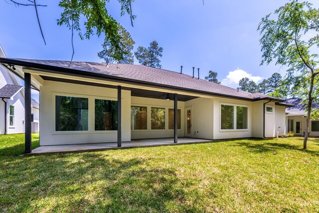 rear view of house featuring a lawn, ceiling fan, and a patio