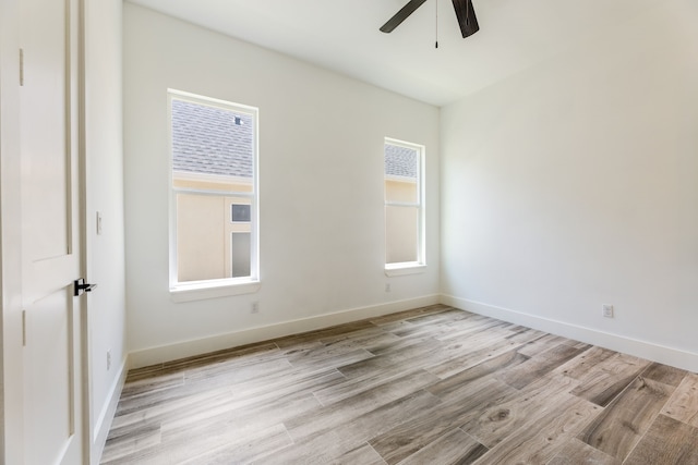 empty room with light wood-type flooring and ceiling fan