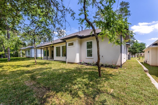 rear view of house featuring a yard