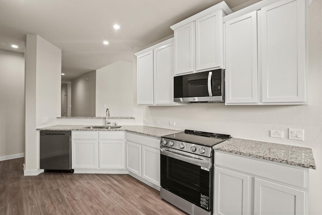 kitchen featuring white cabinetry, sink, light wood-type flooring, and appliances with stainless steel finishes