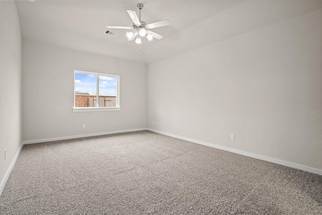 carpeted empty room with vaulted ceiling and ceiling fan