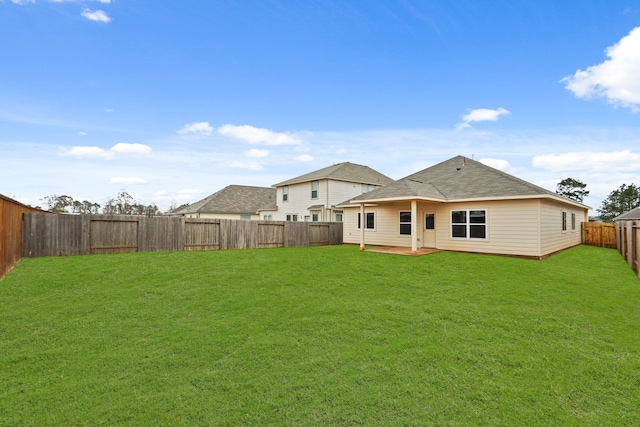 rear view of house featuring a yard