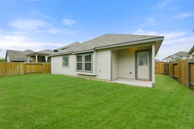 back of property with a lawn and a patio area