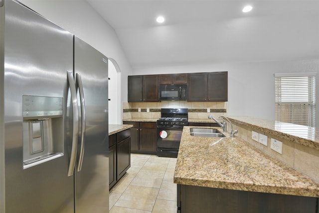 kitchen featuring black appliances, backsplash, sink, lofted ceiling, and light tile patterned flooring