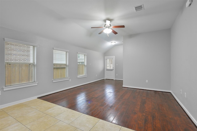 empty room with light wood-type flooring, ceiling fan, and vaulted ceiling