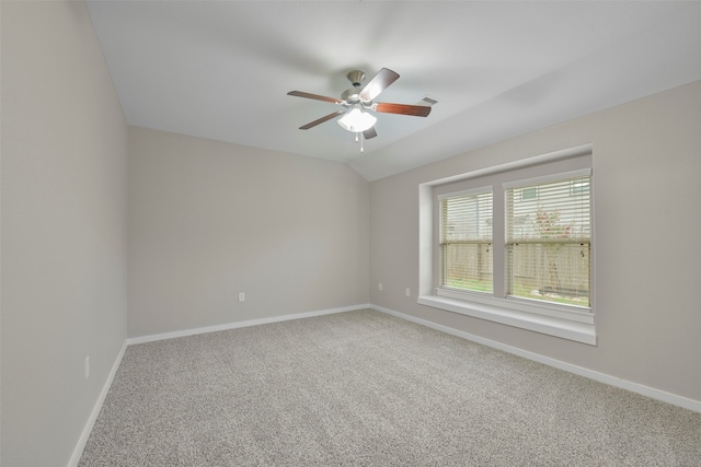 spare room featuring lofted ceiling, ceiling fan, and carpet floors