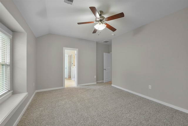 carpeted empty room featuring lofted ceiling and ceiling fan