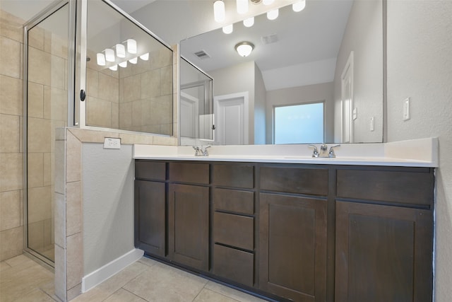 bathroom featuring tile patterned flooring, walk in shower, and vanity