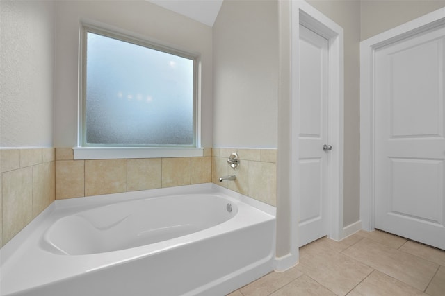 bathroom with tile patterned flooring and a bathtub