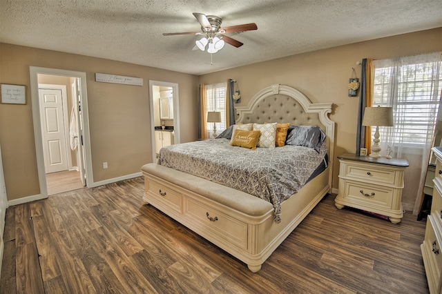 bedroom with ceiling fan, a textured ceiling, ensuite bath, and dark hardwood / wood-style floors