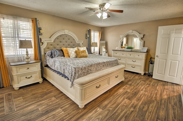 bedroom with a textured ceiling, dark hardwood / wood-style floors, and ceiling fan