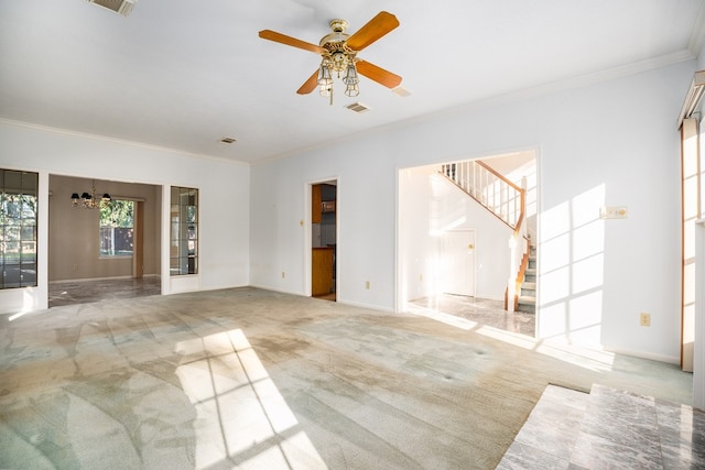 spare room with light colored carpet, ceiling fan with notable chandelier, and ornamental molding