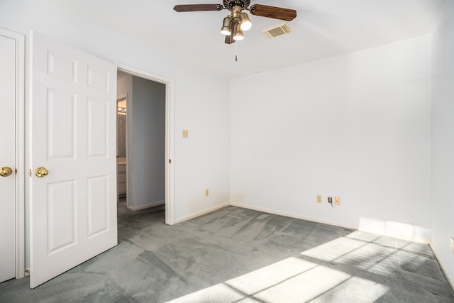 unfurnished room with light colored carpet and ceiling fan