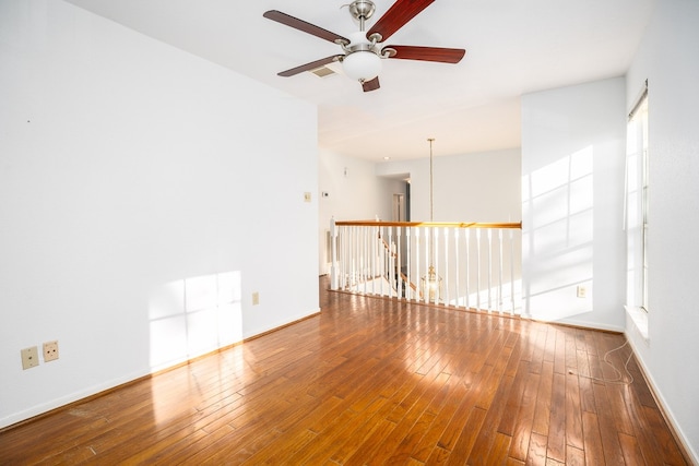 spare room with ceiling fan and hardwood / wood-style flooring