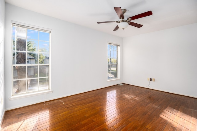 empty room featuring ceiling fan and hardwood / wood-style floors