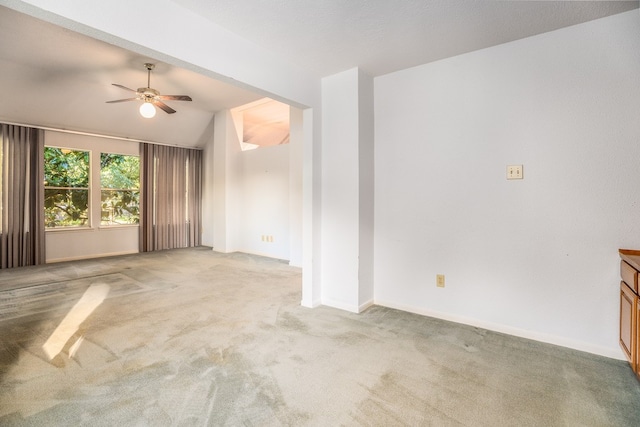 carpeted spare room with ceiling fan and lofted ceiling