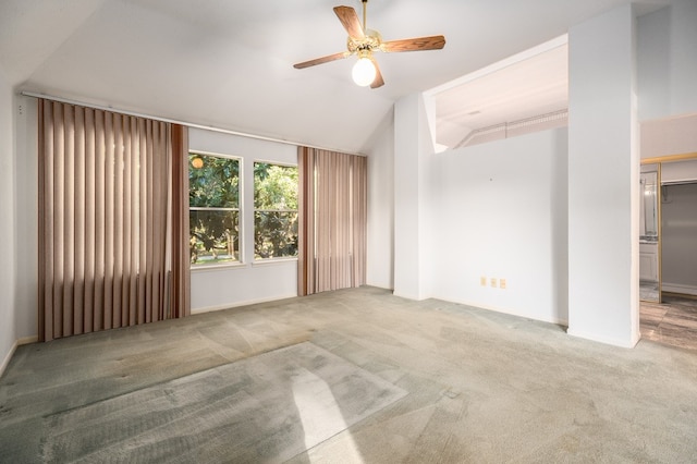 carpeted spare room featuring ceiling fan and lofted ceiling