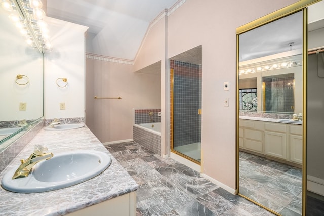 bathroom featuring plus walk in shower, vanity, and vaulted ceiling