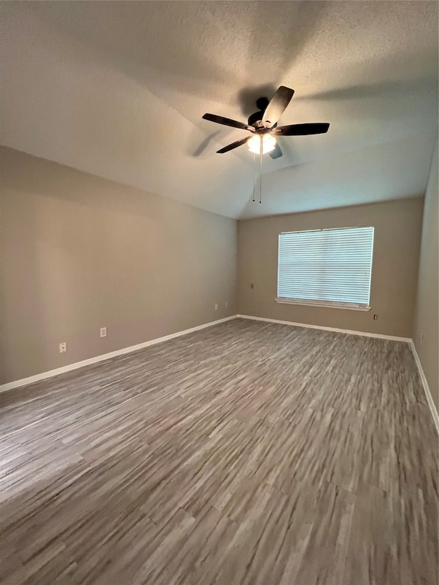 empty room with a textured ceiling, hardwood / wood-style flooring, and ceiling fan