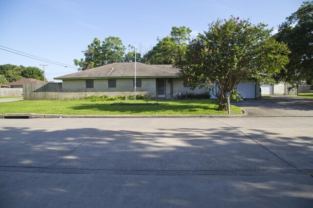 view of front facade with a garage and a front lawn