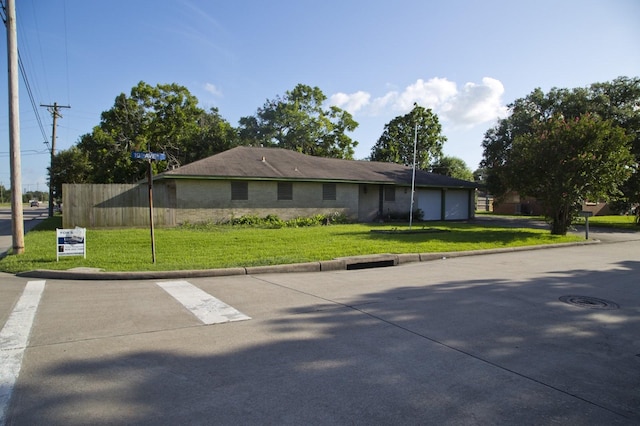 view of front of home with a front yard and a garage