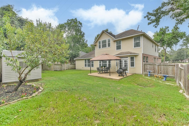 back of property featuring a patio area, a storage shed, and a lawn