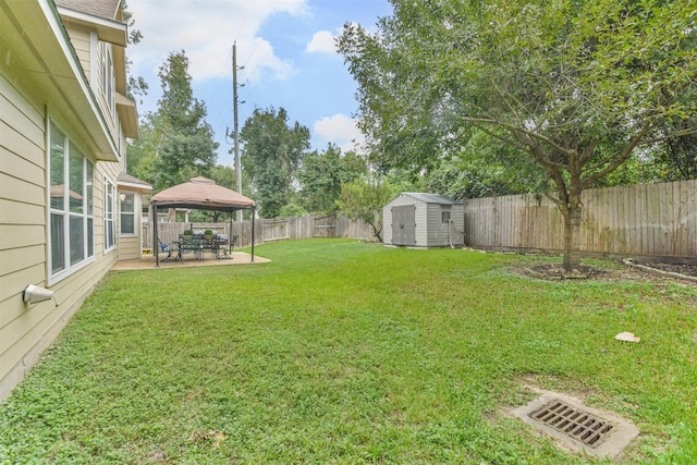 view of yard with a gazebo, a patio, and a shed