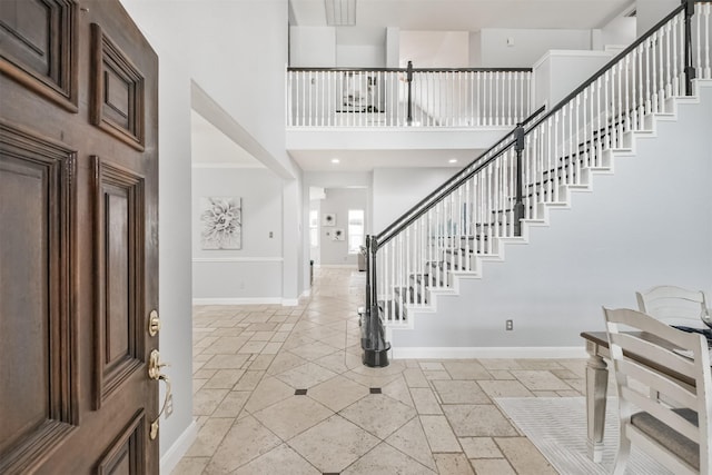 entryway featuring a towering ceiling