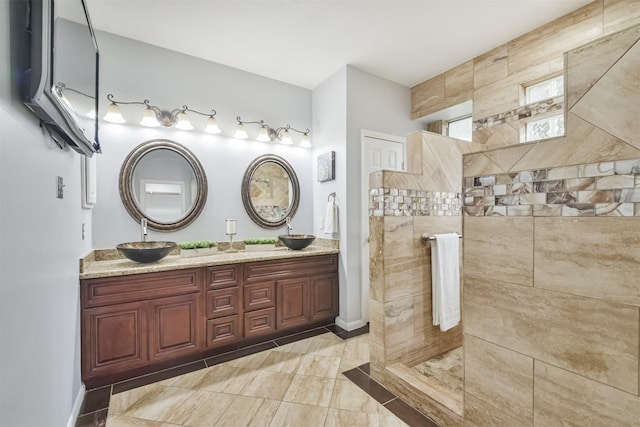 bathroom with tiled shower and vanity