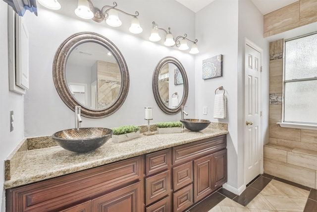 bathroom featuring a wealth of natural light, tile patterned floors, and vanity